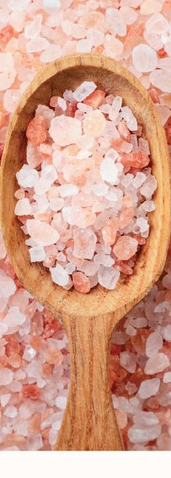 Himalayan pink salt crystals on a wooden spoon